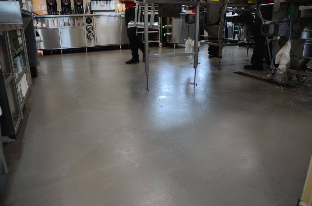 a commercial kitchen with epoxy floor